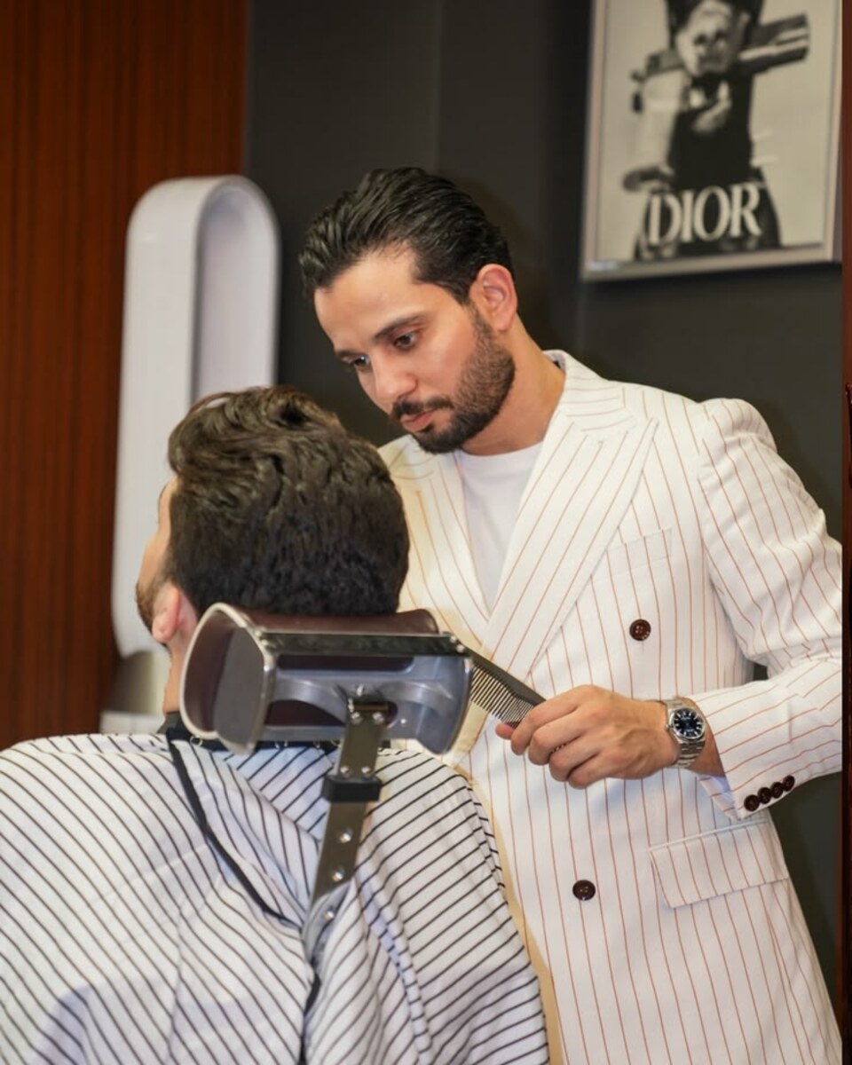 The barber combing a client's hair